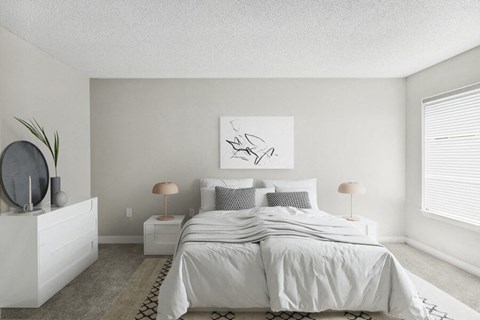 a white bedroom with a bed and a white dresser