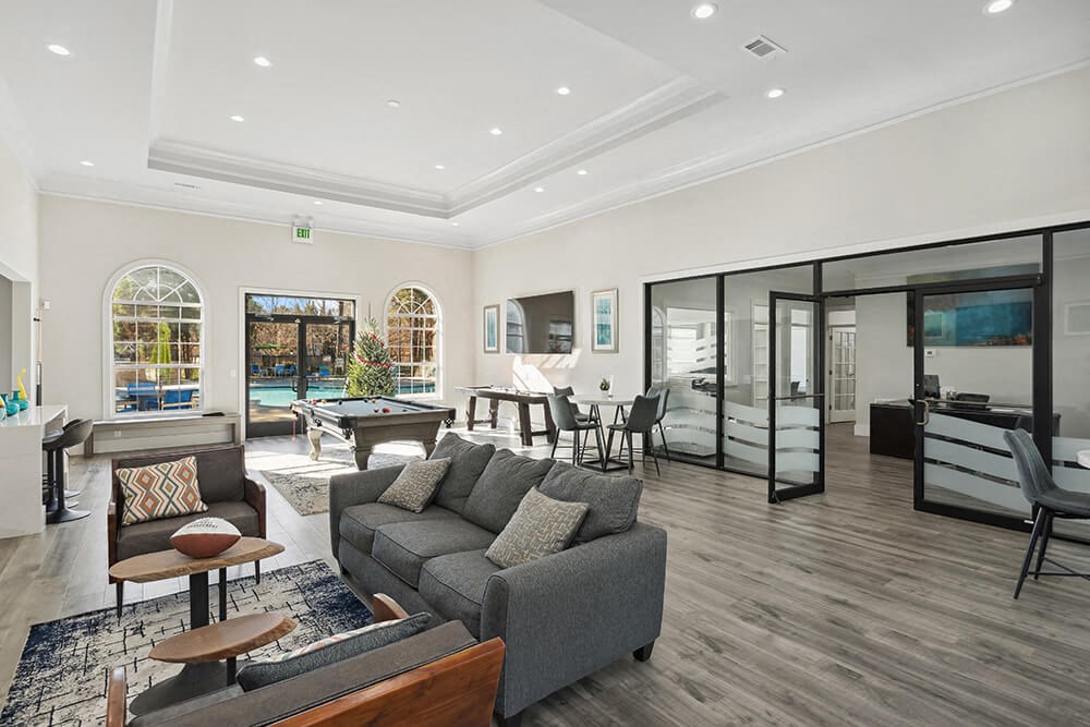 Community Clubhouse with Lounge Furniture and Game Tables at Shadow Ridge Apartments in Riverdale, GA.
