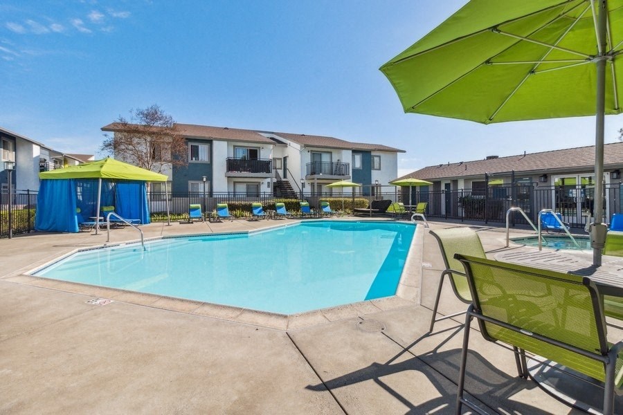 Swimming pool and pool deck with loungers and tables