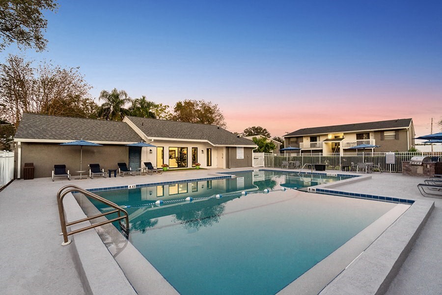 Community Swimming Pool with Pool Furniture at Arbors at Orange Park Apartments located in Orange Park, FL.