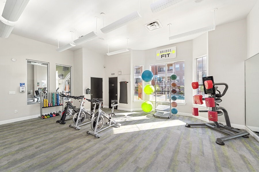 Community Fitness Center with Equipment at Chapel Hill Apartments located in Lewisville, TX.
