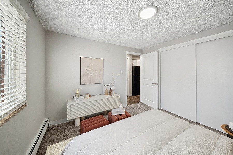 Model Bedroom with Carpet and Closet at Esprit at Cherry Creek Apartments in Glendale, CO.