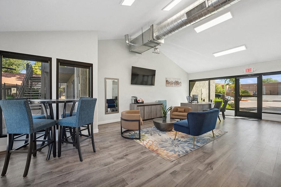 Community Clubhouse with Lounge Furniture and TV at Villages at Metro Center Apartment located in Phoenix, AZ.