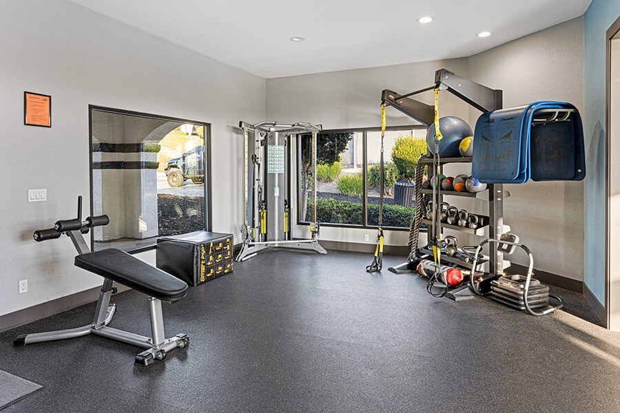 Community Fitness Center with Equipment at Santa Fe Ranch Apartments located in Carlsbad, CA.