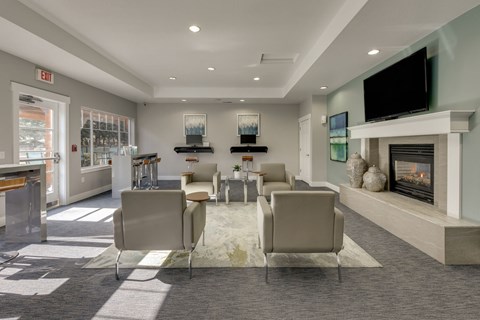 A living room with a fireplace and a television on the wall.