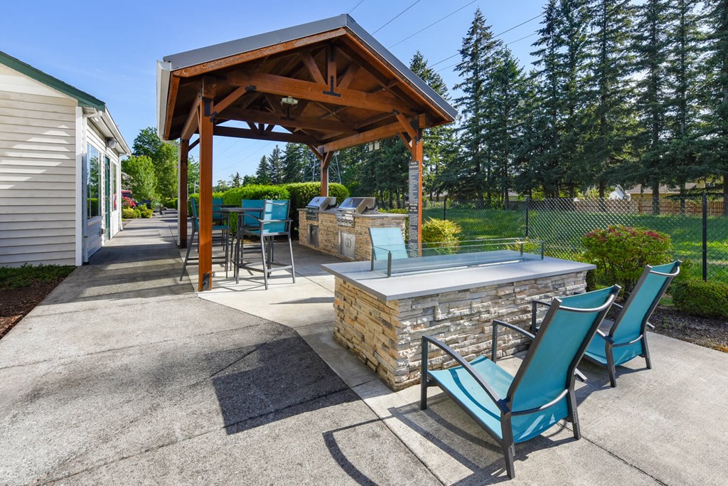 Outdoor Fire Pit & BBQ Area at Landings at Morrison Apartments located in Gresham, OR.