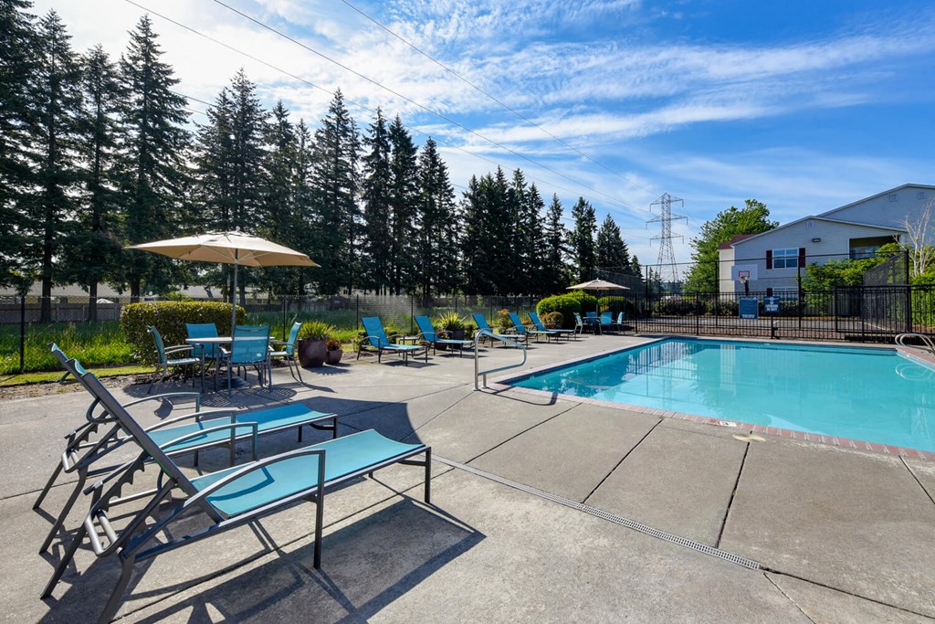 Community Swimming Pool with Pool Furniture at Landings at Morrison Apartments located in Gresham, OR.