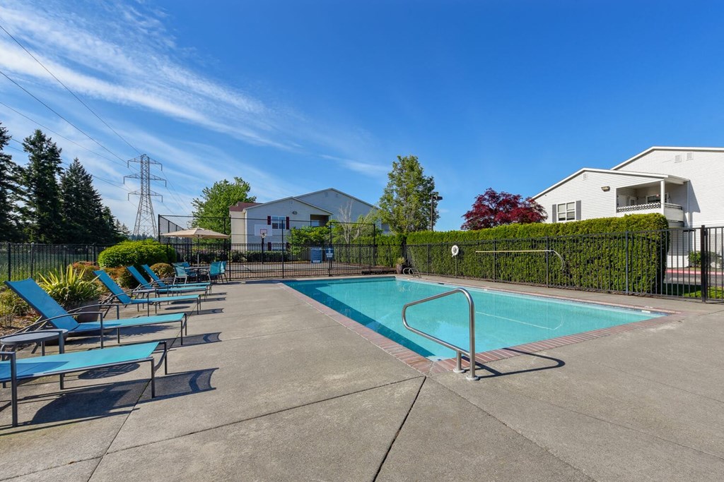 Community Swimming Pool with Pool Furniture at Landings at Morrison Apartments located in Gresham, OR.