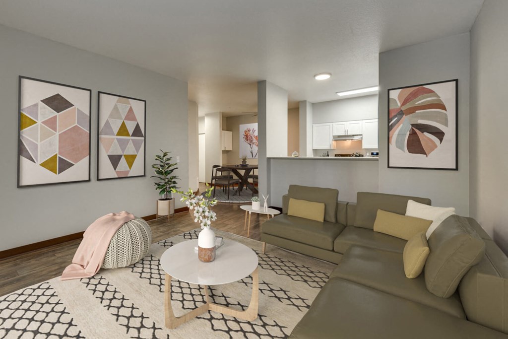 Model Living Room with Wood-Style Flooring and View of Kitchen at Landings at Morrison Apartments located in Gresham, OR.