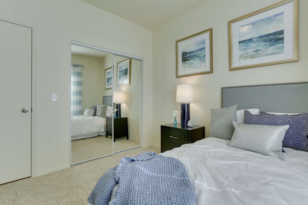 Model Bedroom with Carpet and Closet at Landings at Morrison Apartments located in Gresham, OR.
