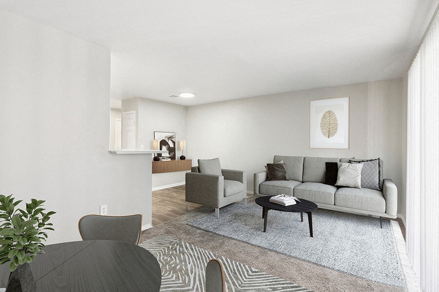 Model Living Room and Dining Room Area with Carpet at Loma Vista Apartments in Las Vegas, NV.