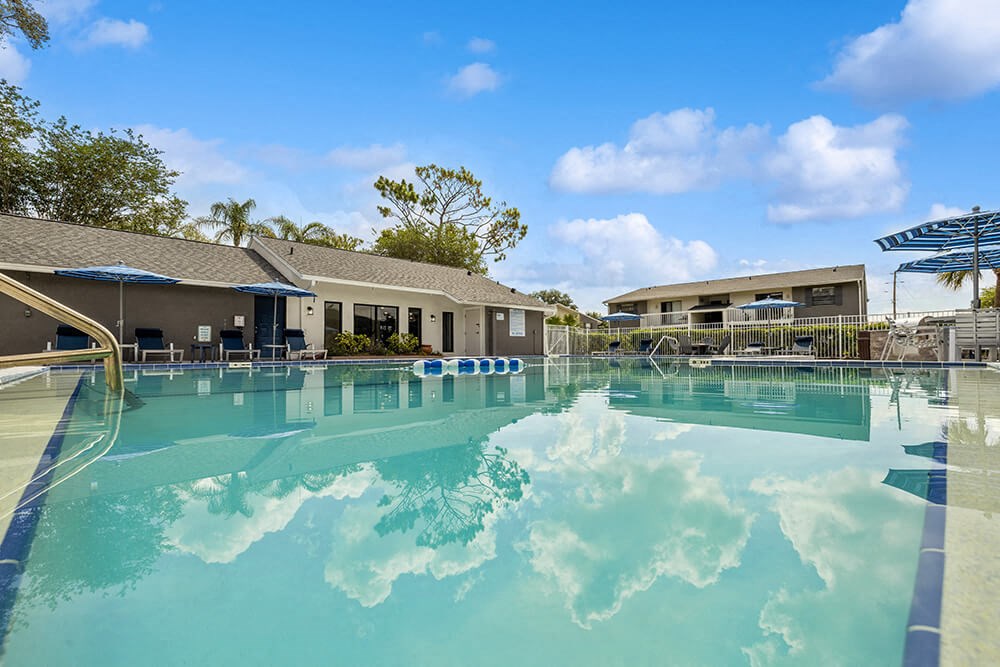 Sparkling swimming pool with clubhouse in background