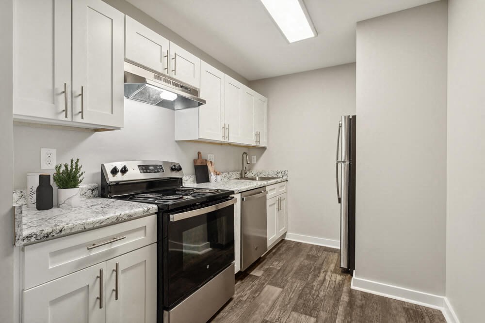Model kitchen with white cabinets and stainless steel appliances