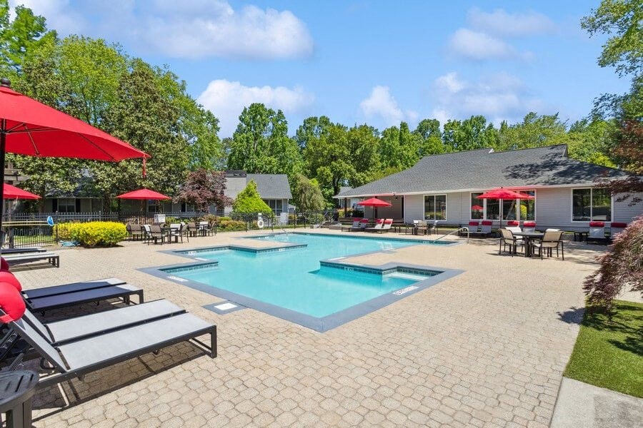 Community Swimming Pool with Pool Furniture at Dunwoody Village Apartments in Atlanta, GA.