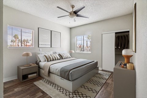 a bedroom with a bed and a ceiling fan