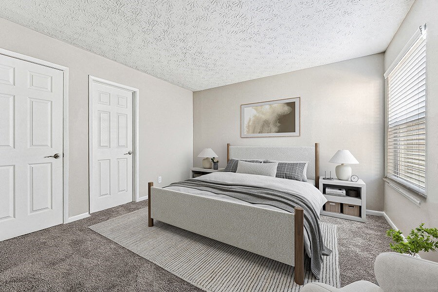 Model Bedroom with Carpet and Window View at Paramont Apartments in Duluth, GA.