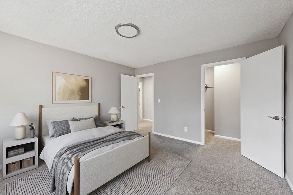Model Bedroom with Carpet and Walk In Closet at Spring Forest Apartments in Raleigh, NC.