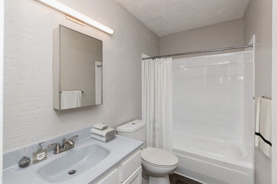 Model Bathroom with Wood-Style Flooring at Indigo Park Apartments in Albuquerque, NM.