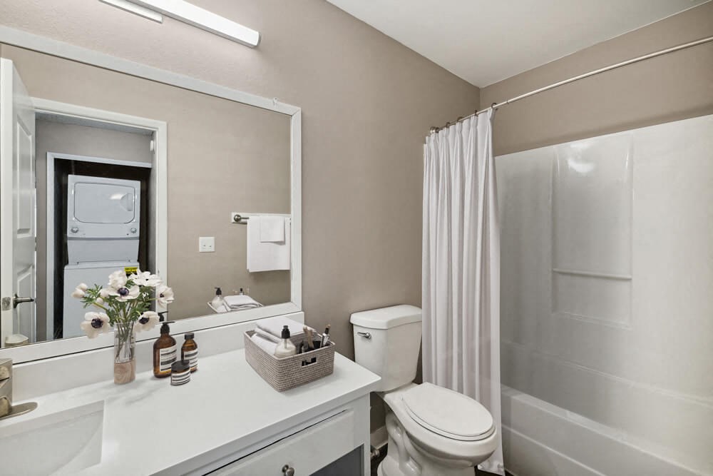 Model bathroom with white vanity at Vue at Baymeadows Apartments in Jacksonville, Florida