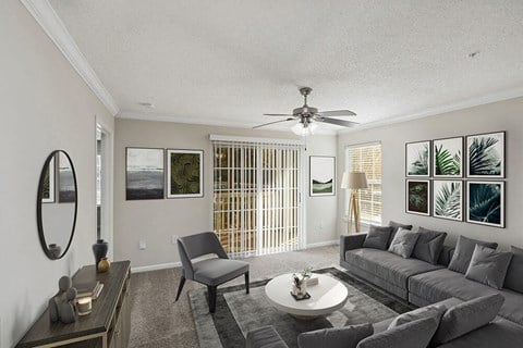 Model Living Room with Carpet and Patio Accessibility at Shadow Ridge Apartments in Riverdale, GA.