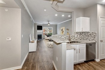 Model Kitchen/Living Room Model kitchen and wood floors with living room and balcony sliding door in background - Photo Gallery 5