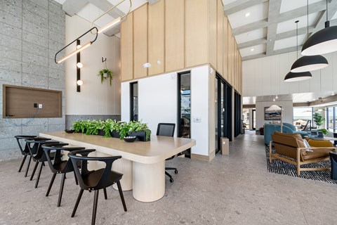 A modern office space with a long table and chairs.
