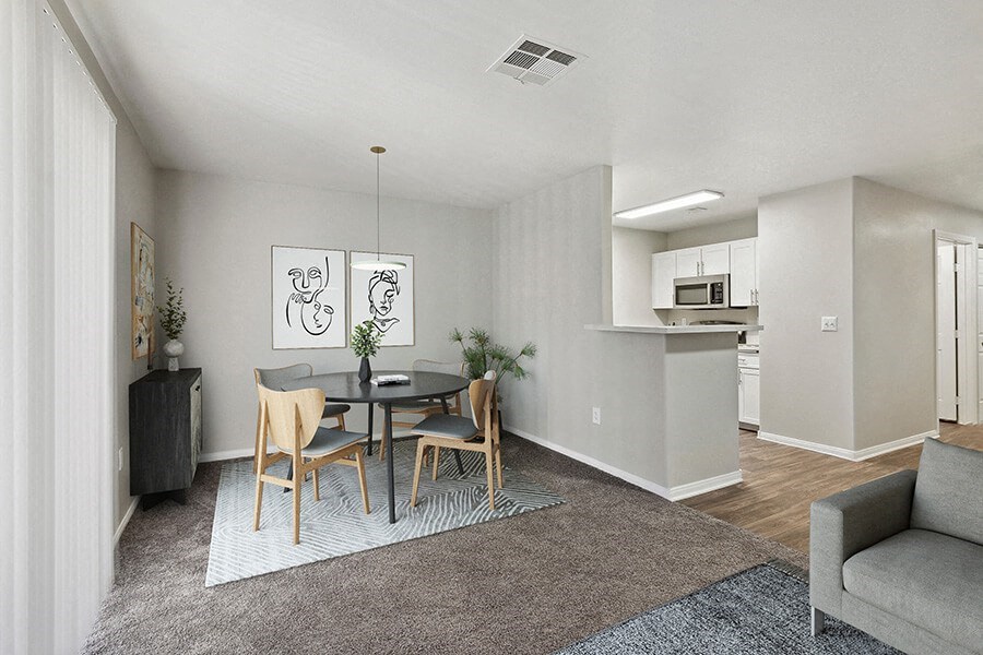 Model Dining Room and Kitchen Area with View of Living Room at Loma Vista Apartments in Las Vegas, NV.