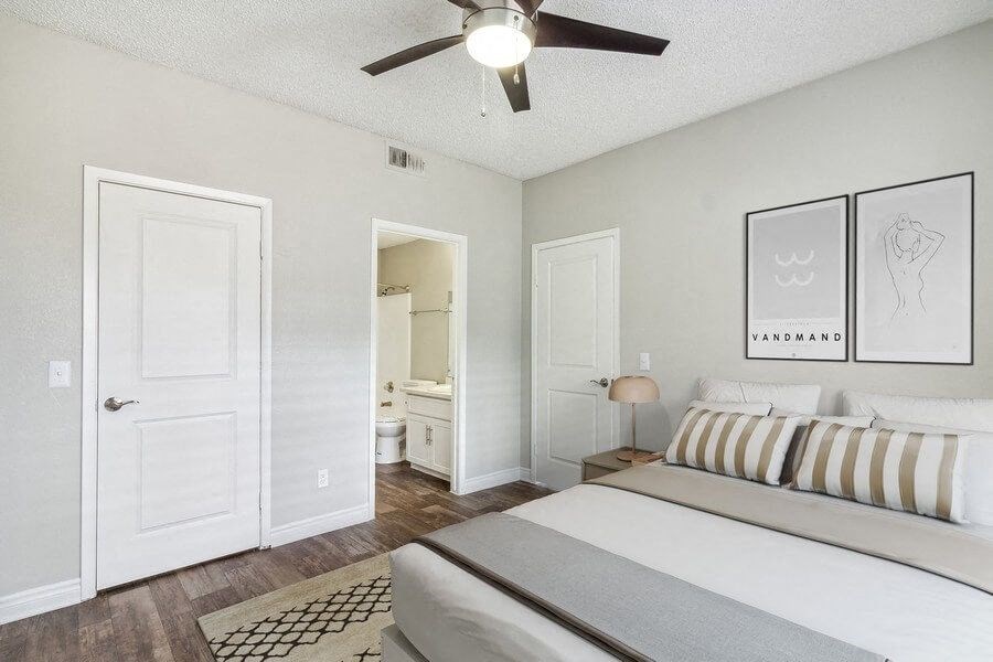 a bedroom with a bed and a ceiling fan