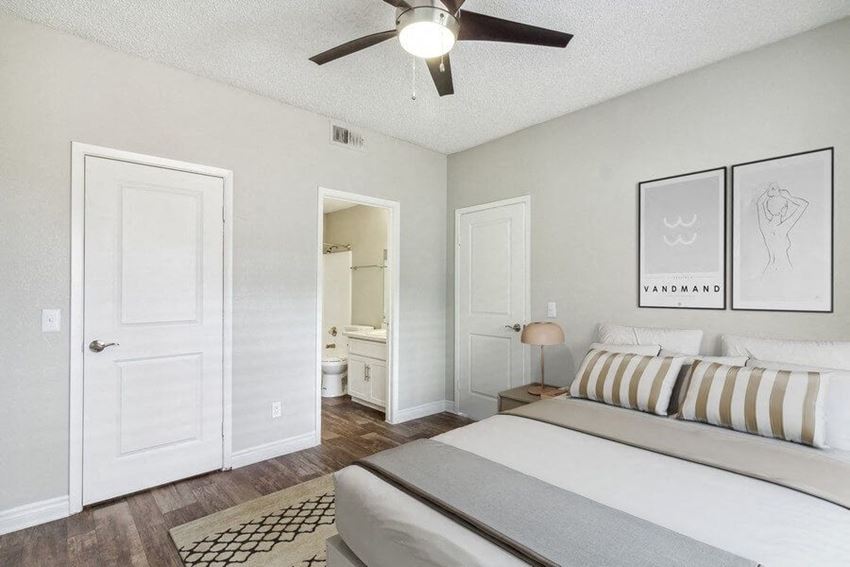 a bedroom with a bed and a ceiling fan - Photo Gallery