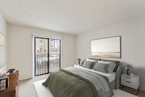 Two-Bedroom Luxury Apartments in Marietta, GA - The Grandstand - A Bedroom With A Made Bed, Neutral Decor, Nightstands With Lamps, And Sliding Glass Doors.
