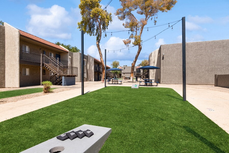 community cornhole area on artificial turf at Villages at Metro Center, Phoenix, 85051