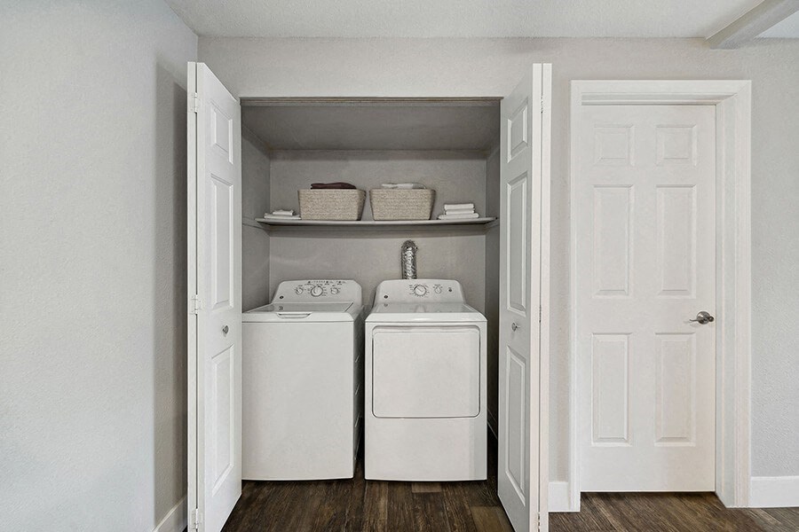 Model Laundry Room with Wood-Style Flooring at Central Flats Apartments in Kent, WA.