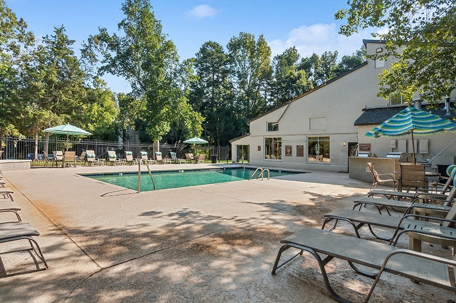 Community Swimming Pool with Pool Furniture at Stoney Trace Apartments in Charlotte, NC.