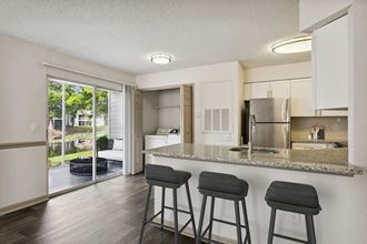 Model kitchen with bar at Retreat at Crosstown Apartments