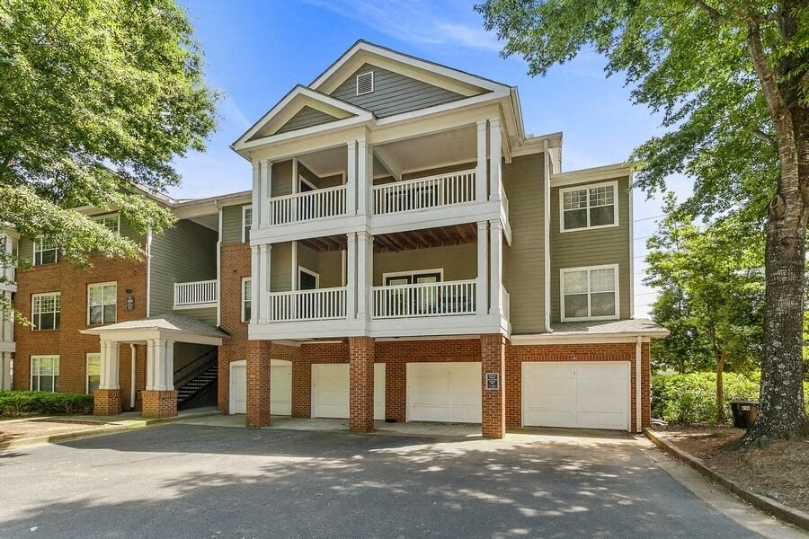 Apartment exterior showcasing garages on first floor of three story building