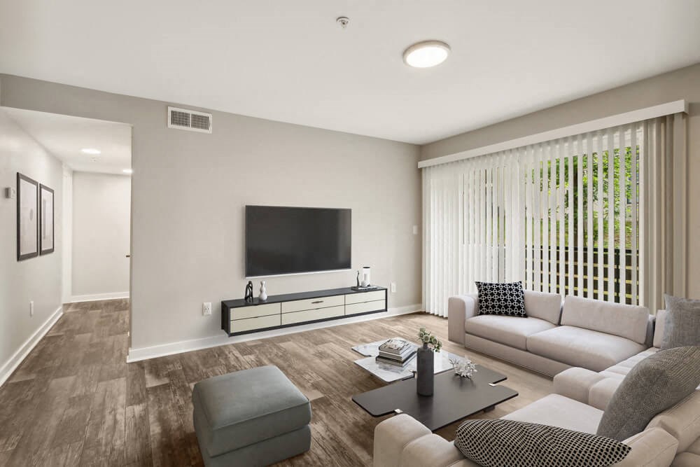 Model living room filled with furniture and a flat screen tv
