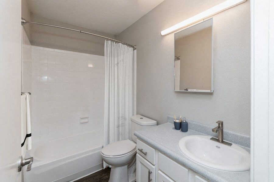 Model Bathroom with Wood-Style Flooring at Indigo Park Apartments in Albuquerque, NM.