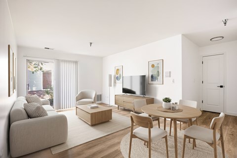 A living room with a couch, chairs, and a coffee table.
