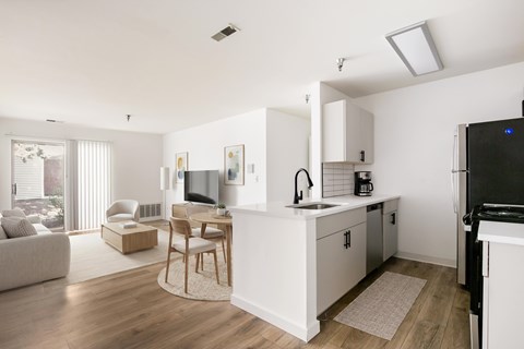 A modern kitchen with a dining table and chairs.