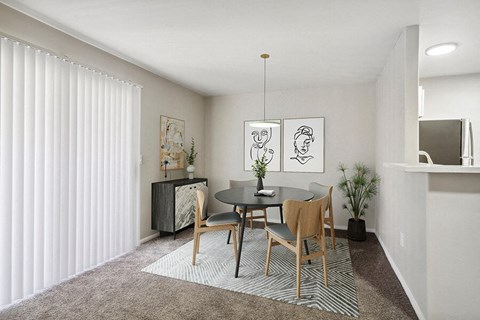 Model Dining Room with Carpet at Loma Vista Apartments in Las Vegas, NV.