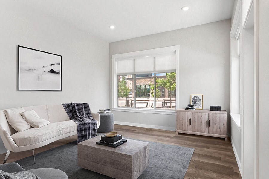 Model Living Room with Wood-Style Flooring and Window View at Seven Skies Apartments located in Sandy, UT.