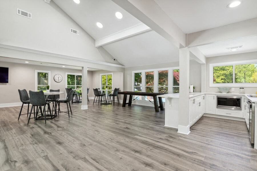 Community Clubhouse with Island Bar and Lounge Furniture and Game Tables at Dunwoody Village Apartments in Atlanta, GA.
