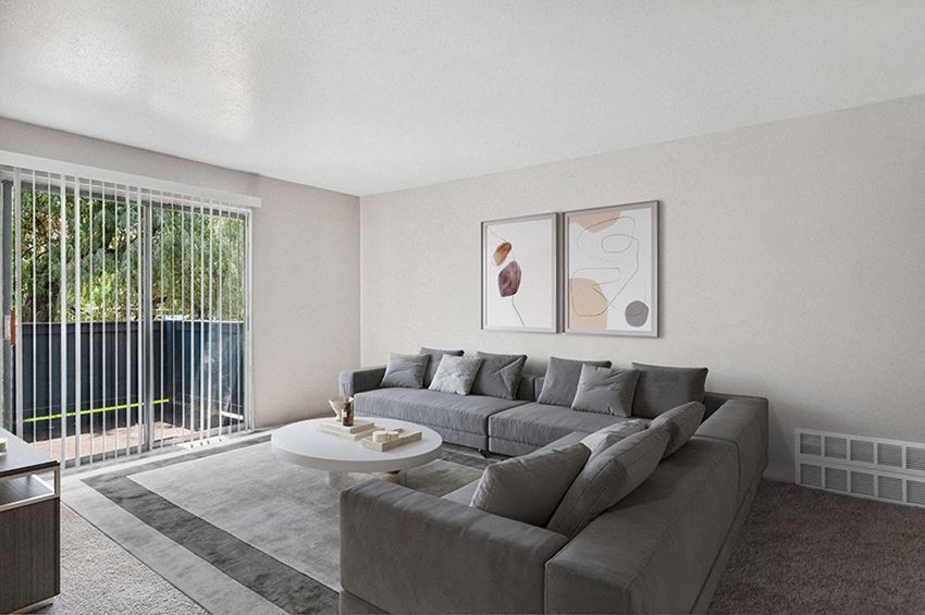 Model Living Room with Carpet and Patio Accessibility at Monaco Apartments in Salt Lake City, UT.