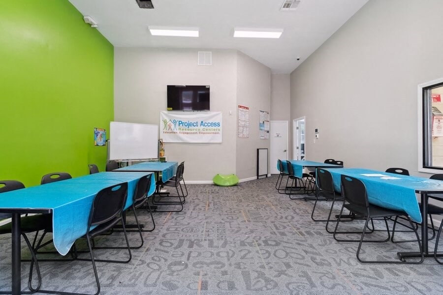 Clubhouse common room with long tables and chairs