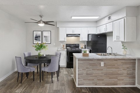 an open kitchen and dining area with a table and chairs