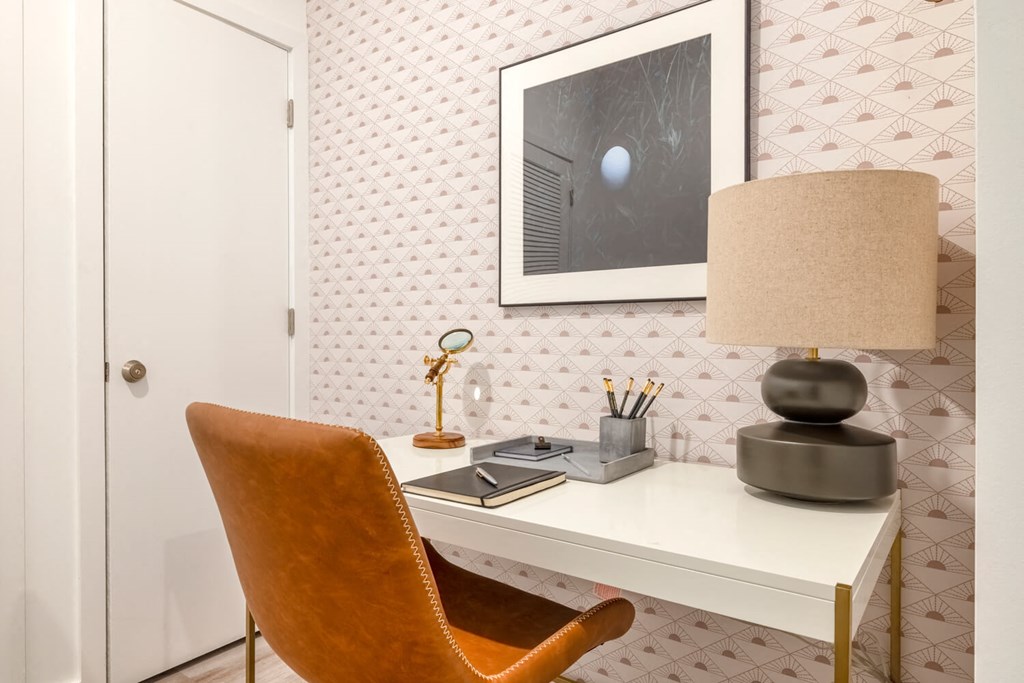 Model room with desk with a lamp and a chair in a room