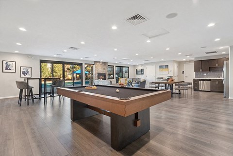 Community Clubhouse with Lounge Furniture and Pool Table Area at Liberty Creek Apartments in Aurora, CO.