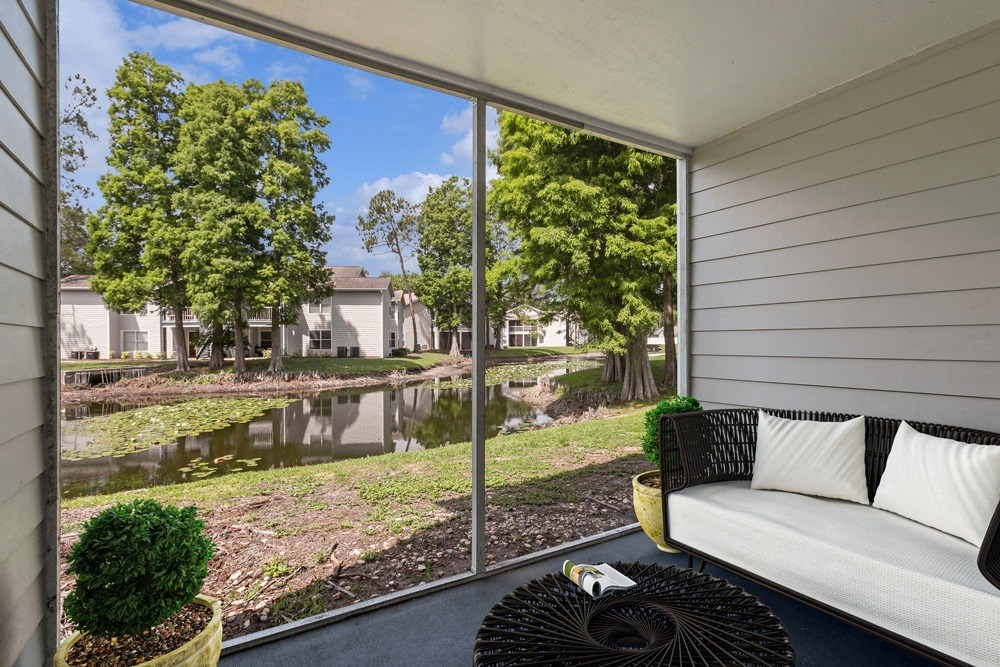 Patio with a couch and a cof fee table at Retreat at Crosstown Apartments