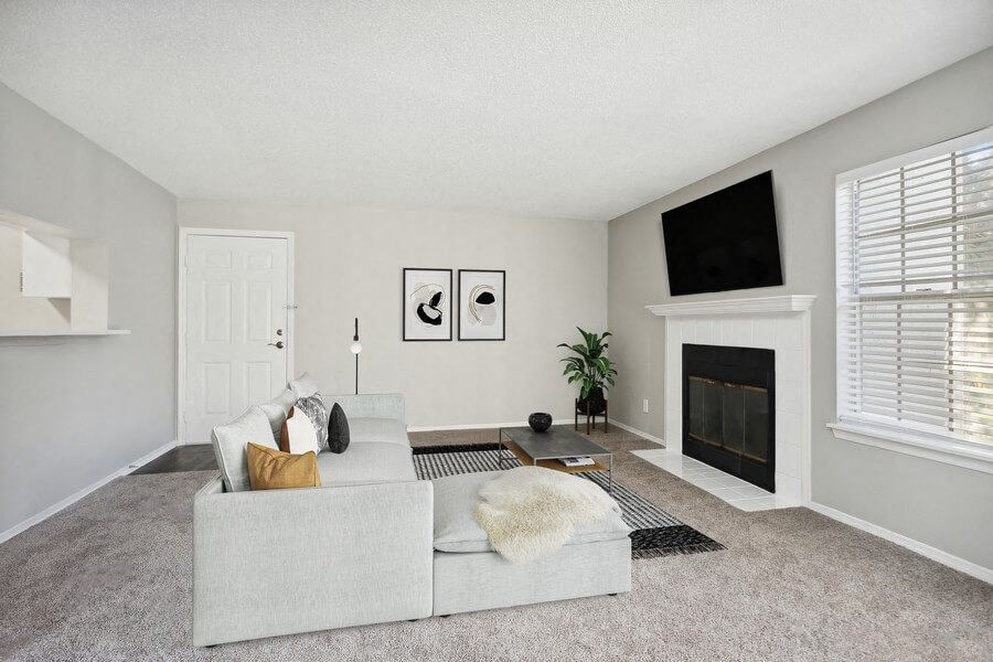 Model Living Room with Front Door and a Fireplace at Caribbean Breeze Apartments in Tampa, FL.
