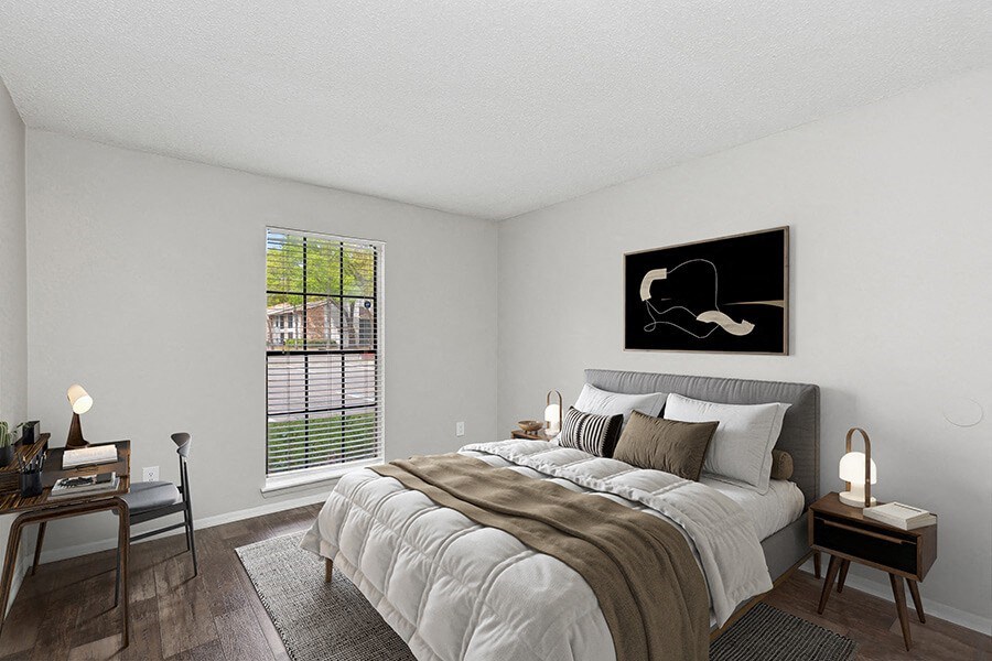 Model Bedroom with Wood-Style Flooring and Window View at Grand Pavilion Apartments in Tampa, FL.